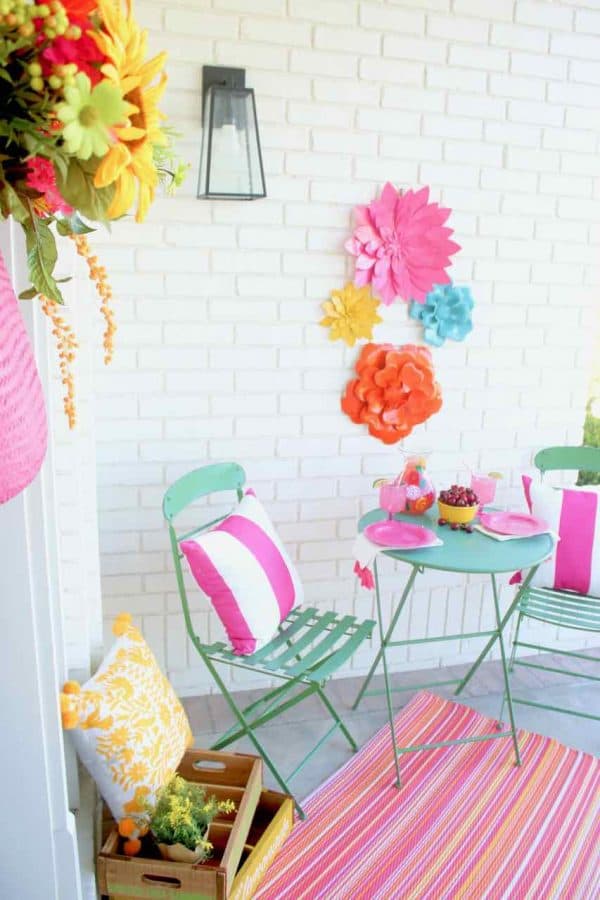 Front Porch Summer Decor. Beautiful hues of pink, yellow, orange, and more make for a colorful and happy porch | Design Dazzle