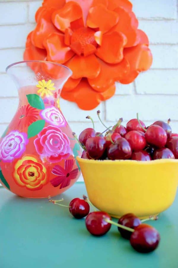 Front Porch Summer Decor. Beautiful hues of pink, yellow, orange, and more make for a colorful and happy porch | Design Dazzle