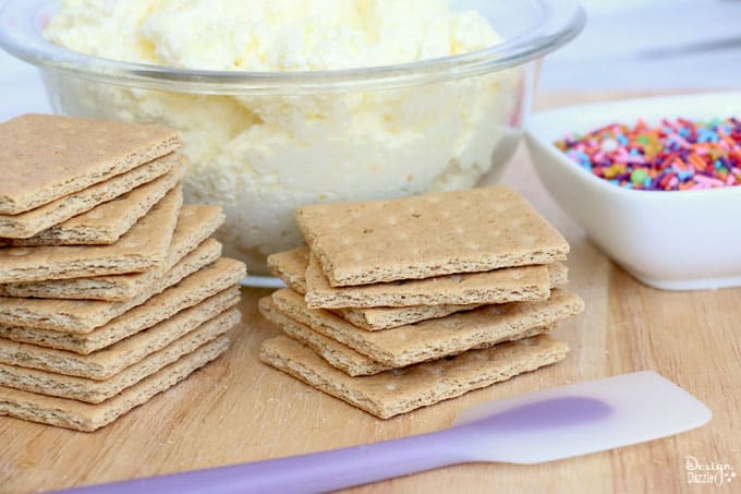 These cute stuffed graham crackers are a great afternoon snacks for the kiddos! Absolutely easy to make! Have fun preparing them, especially when it comes to the sprinkles! - Design Dazzle