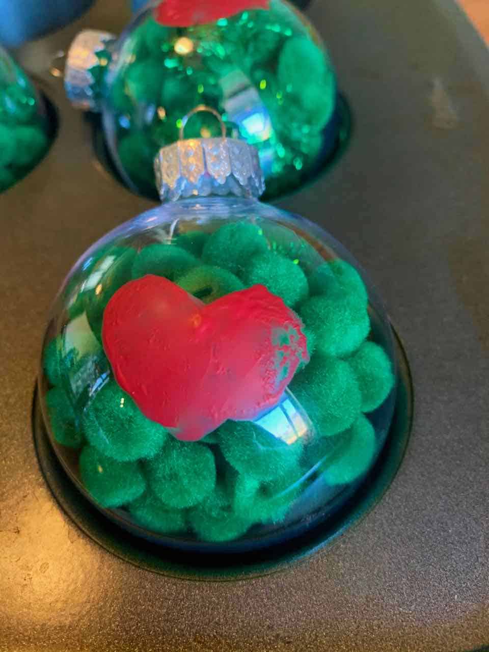 If you're looking for an easy Christmas ornament craft, this super cute Grinch-themed DIY holiday ornament is perfect!