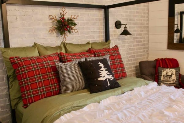 Decorating the bedroom for the holidays with plaid and Christmas greenery!