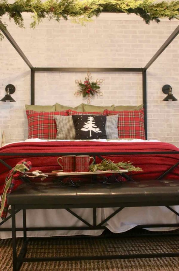 Decorating the bedroom for the holidays with plaid and Christmas greenery!