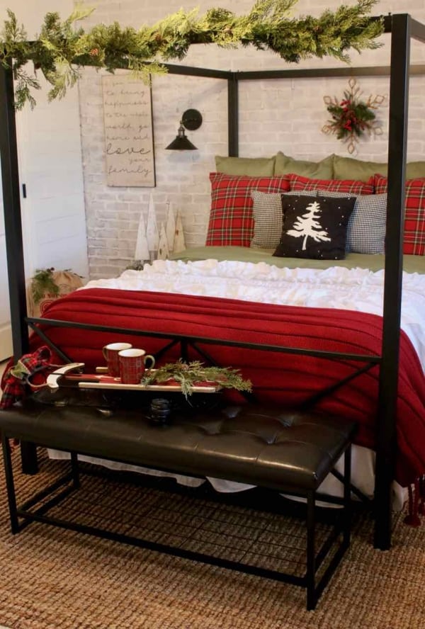 Decorating the bedroom for the holidays with plaid and Christmas greenery!